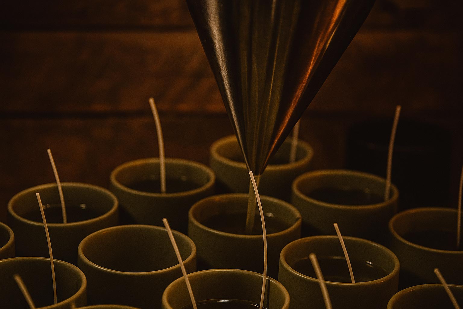Wild England's Natural Soy Candles. Candle-making process with wicks being dipped into molten wax.
