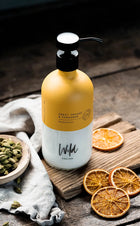 Wild England's natural hair conditioner, in sweet orange and cardamom scent, in their sustainable glass bottle