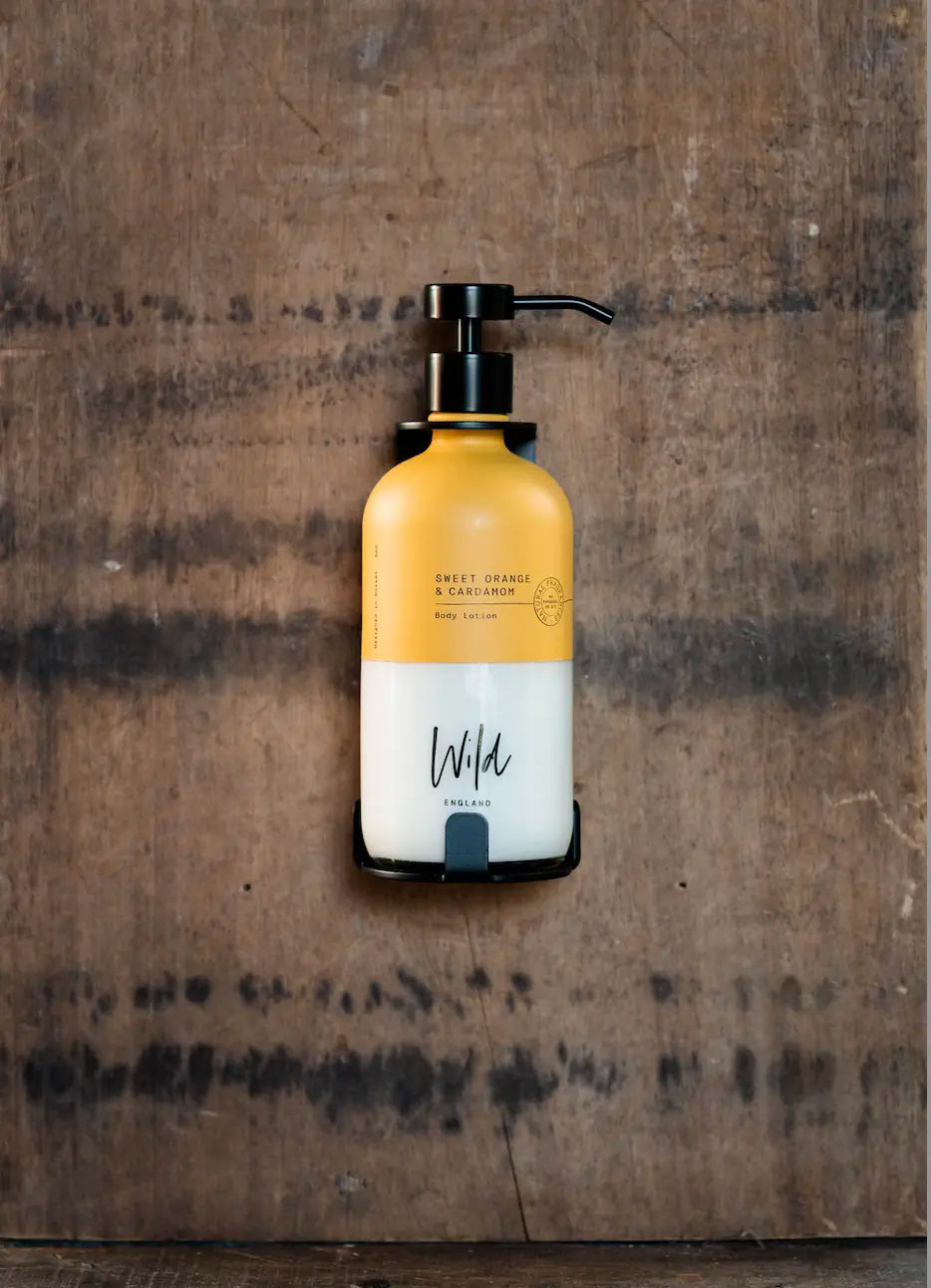 Matt Black Single Bracket holding Sweet Orange and Cardamom body lotion