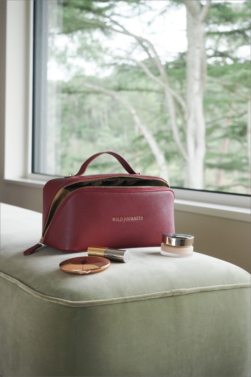 Wild Atelier Special Edition Leather Travel Case sat on footstool with make up