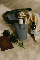 Wild England natural hand and body wash lavender and eucalyptus travel pouch 50ml sat next too sunglasses and passport