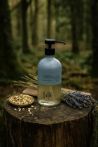 Wild England natural hand and body wash lavender and eucalyptus 475ml  in woodland setting on stump next to lavender sprigs
