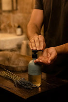 Wild England natural hand and body wash lavender and eucalyptus 475ml being applied to hands in bathroom setting
