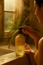 Wild England Almost Perfect sweet and orange cardamom natural hand and body wash 475ml bottle used by model in bathroom