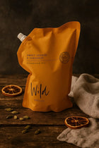 Sweet Orange and Cardamom Cleaning Gel Refill on rustic wooden surface with dry orange slices