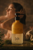 Wild England natural sweet orange and cardamom shampoo 475m bottle in shower close up