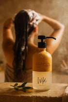 Wild England natural sweet orange and cardamom shampoo 475m bottle in shower